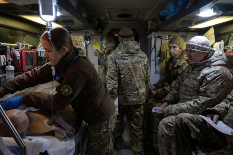 epa11764318 Sofia, a Hospitallers volunteer paramedic, treats a wounded Ukrainian soldier during an evacuation in a medical bus to a hospital, in the Donetsk region, Ukraine, 06 December 2024 (issued 08 December 2024). Each evacuation involves two doctors, three paramedics and a driver, and they can transport more than 20 wounded. The Hospitallers, a Ukrainian volunteer medical battalion, has been providing medical care to Ukrainian soldiers wounded in combat since 2014. The medical battalion's current operations include evacuating patients from medical points near the front line in Donetsk to secure referral hospitals in the Dnipro region. EPA-EFE/MARIA SENOVILLA