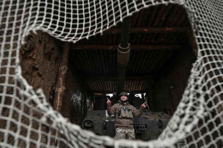 A Ukrainian serviceman of the 118th Separate Mechanized Brigade stands next to a Paladin M109 self-propelled howitzer before firing towards Russian troops, amid Russia's attack on Ukraine, in a front line in Zaporizhzhia region, Ukraine December 3, 2024. REUTERS/Stringer