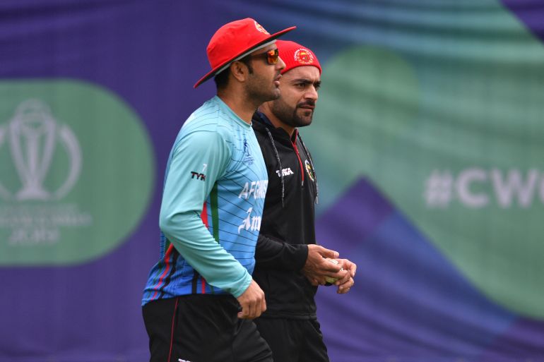 Afghanistan's Mohammad Nabi (L) and Afghanistan's Rashid Khan (R) prepare to bowl in the nets during a training session at the Rose Bowl in Southampton, southern England on June 21, 2019, ahead of their 2019 Cricket World Cup group stage match against India. (Photo by Saeed KHAN / AFP) / RESTRICTED TO EDITORIAL USE