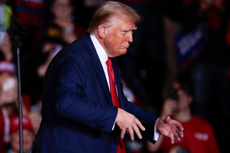 Former US President and Republican presidential candidate Donald Trump gestures as he leaves his last campaign rally at Van Andel Arena in Grand Rapids, Michigan on November 5, 2024.