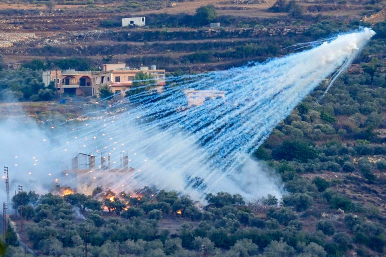A shell that appears to be white phosphorus from Israeli artillery explodes