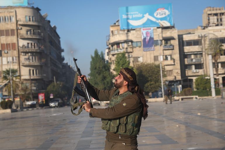 A fighter shoots in the air in downtown Aleppo