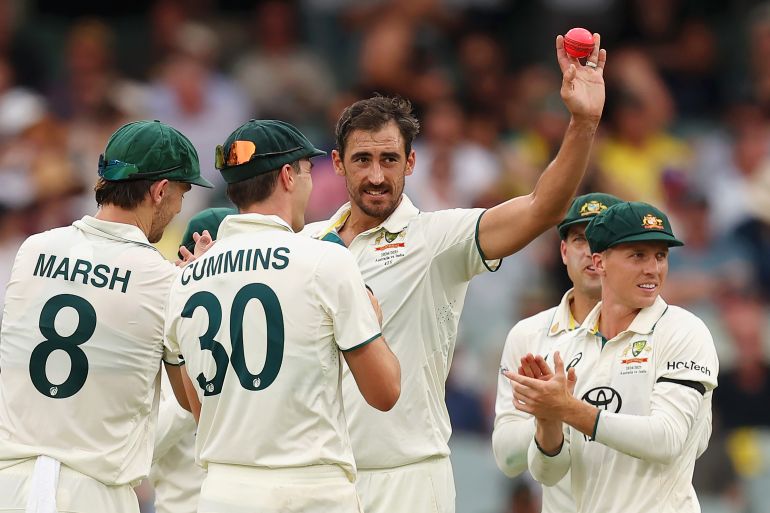 ADELAIDE, AUSTRALIA - DECEMBER 06: Mitchell Starc of Australia celebrates with teammates after dismissing Harshit Rana of India, his fifth wicket of the innings during day one of the Men's Test Match series between Australia and India at Adelaide Oval on December 06, 2024 in Adelaide, Australia. (Photo by Paul Kane/Getty Images)