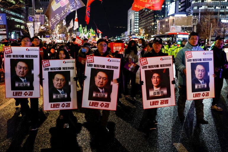 People protest during a candlelight vigil calling for the resignation of South Korean President Yoon Suk Yeol, in Seoul